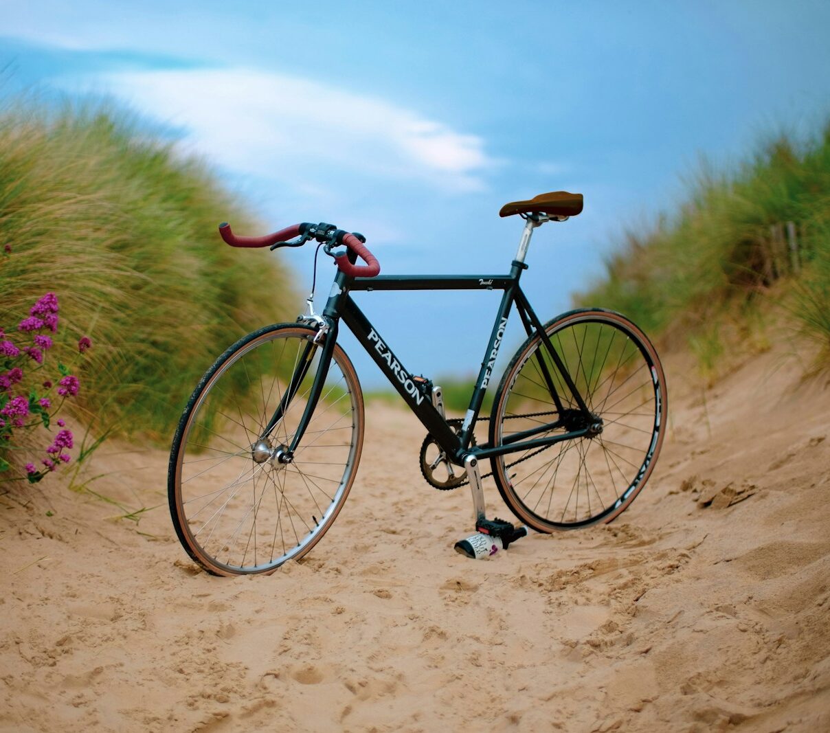 black Pearson road bike on brown sand